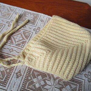 Cream tone knit hat with ear flaps and chin tie. Small adult or reg child size.